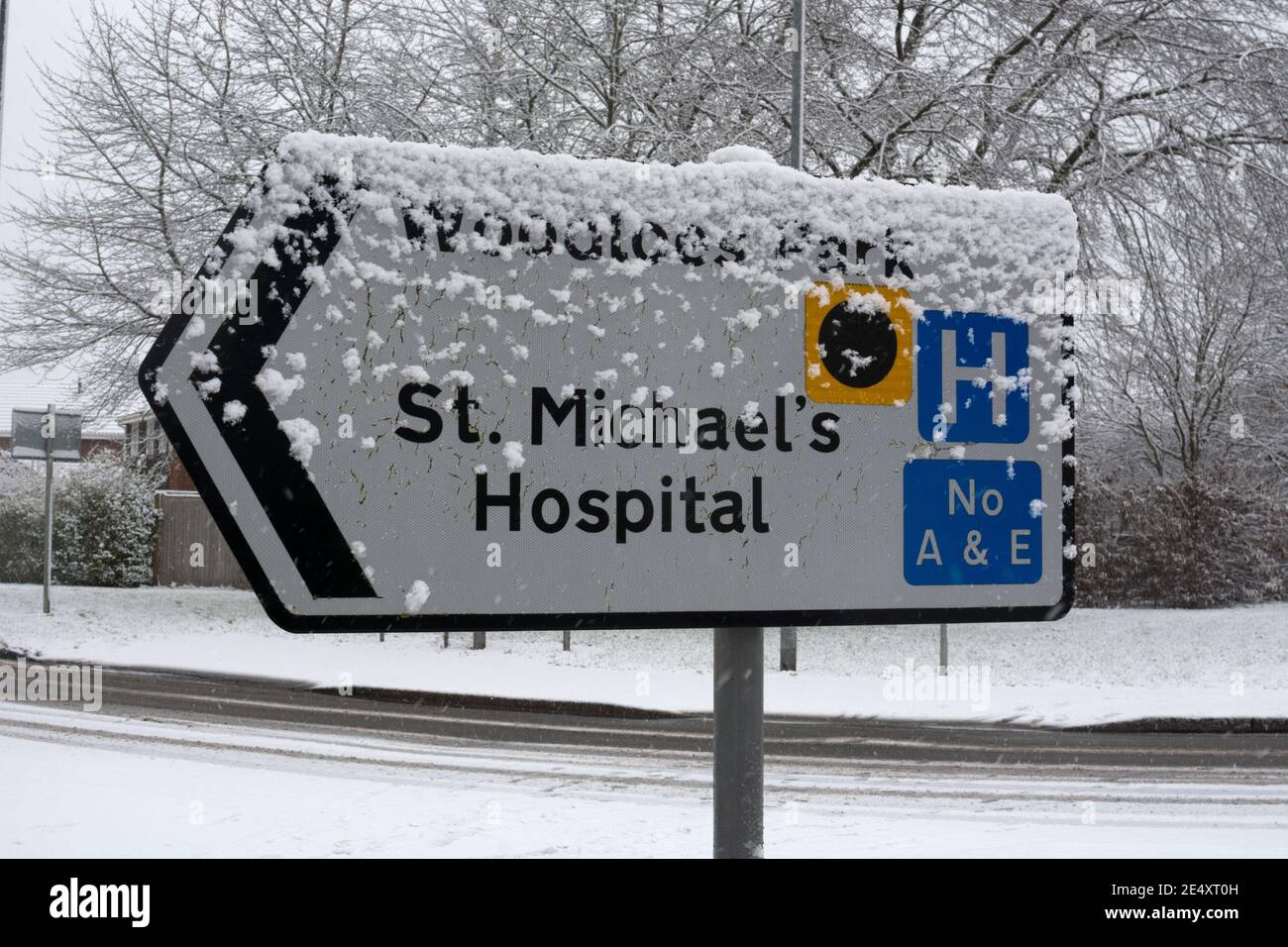 Woodloes Park and St. Michael`s Hospital road sign in snowy weather